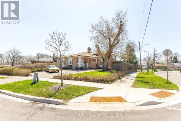 Street view of a residential house with a paved driveway and sidewalk. - 16 Gambello Crescent, Toronto
