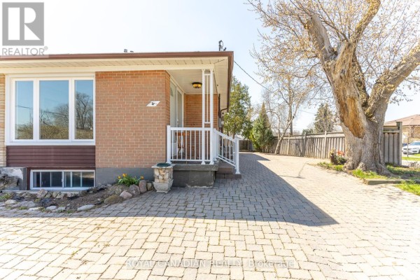 Front exterior of a brick house with a paved driveway and a large tree. - 16 Gambello Crescent, Toronto