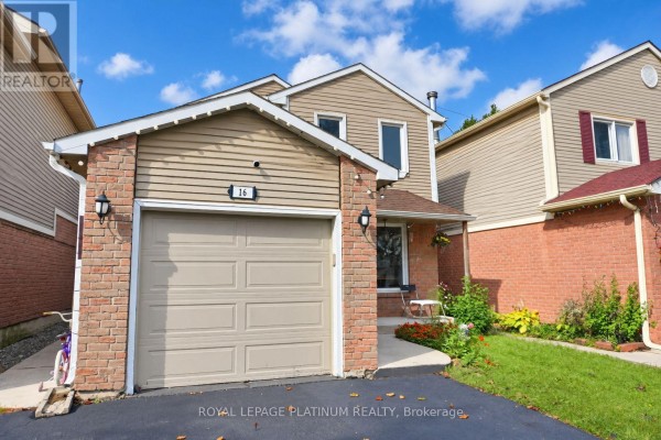 Close-up of the attached garage with a beige door, brick exterior, and a number 16 sign on the siding. - 16 Joshua Court, Brampton