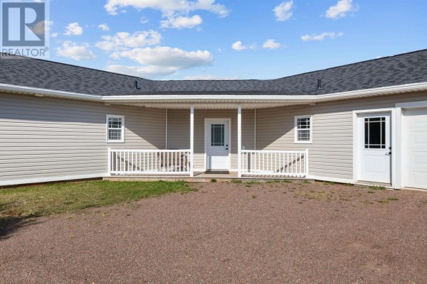 Close-up view of the central entrance of a gray ranch-style house with white railings and a white door. - 16 Old Bedford Road Extension, Blooming Point