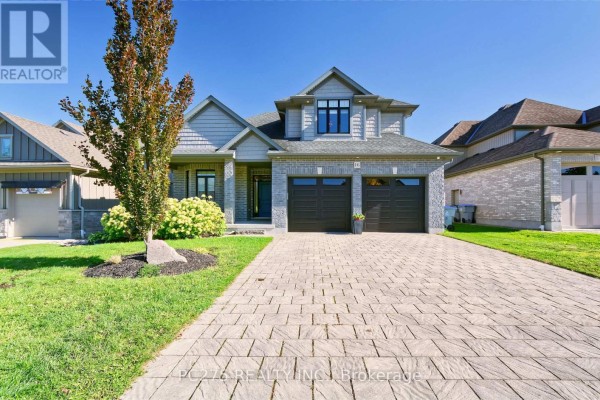 Covered front porch with grey brick walls and a blue front door. - 16 Peregrine Avenue, Middlesex Centre