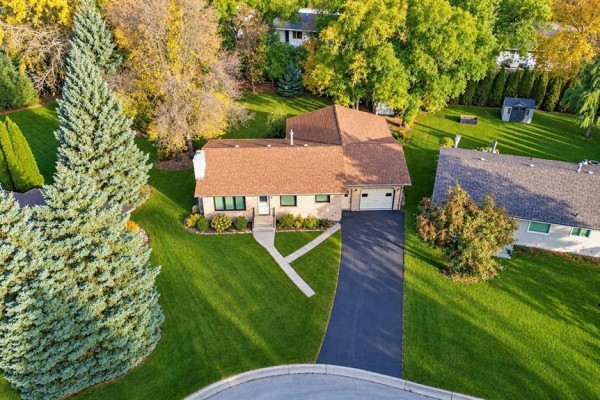 Aerial view of a single-story house with attached garage and large yard. - 16 Pine Crescent, Steinbach