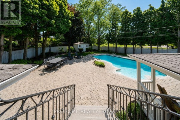 Swimming pool and patio area with dining set and lounge chairs - 16 Tuscay Court Markham