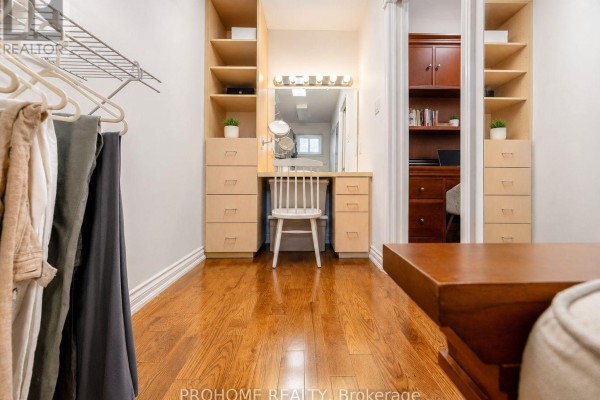 Dressing room with vanity and built-in storage, opening to office - 16 Tuscay Court Markham