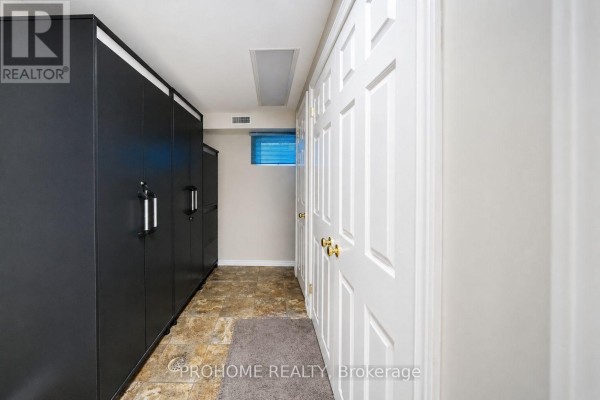 Hallway with black cabinets and white doors - 16 Tuscay Court Markham