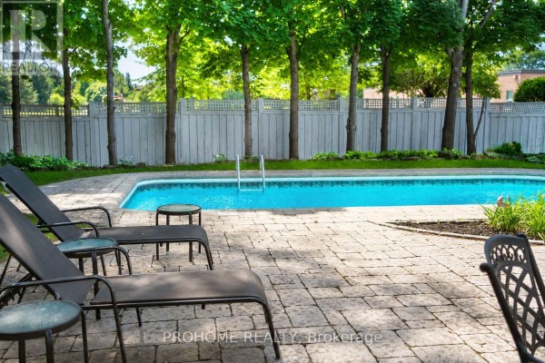 Swimming pool with lounge chairs and paved patio - 16 Tuscay Court Markham