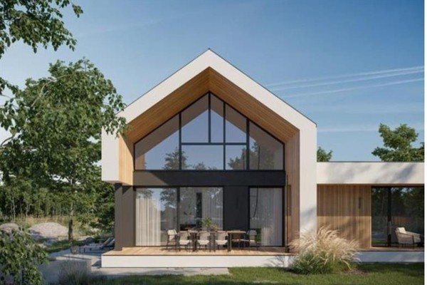Modern house exterior with a gabled roof, large windows, and a deck. - 16 Yamnuska Place, Exshaw