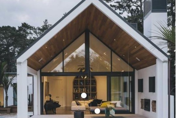 Interior view of a modern house with vaulted ceilings, wood accents, and furniture. - 16 Yamnuska Place, Exshaw