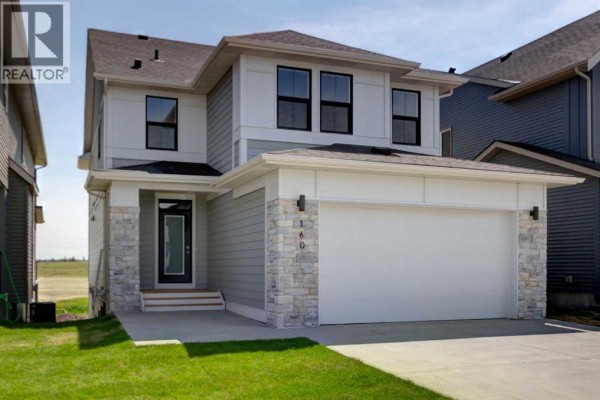 Side exterior view of the house showing the front door and garage. - 160 Copperhead Road Se, Calgary