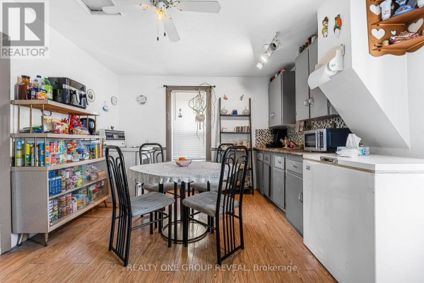 Narrow bathroom with toilet, shower, and decorative shelving - 160 Fares Street, Port Colborne