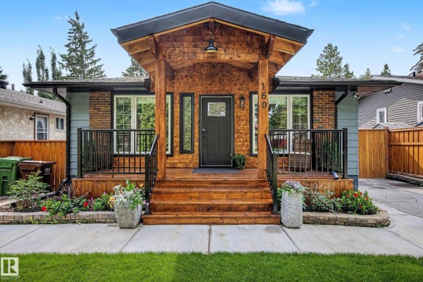 The front door and covered porch of the residential house with wooden beams. - 160 Mission Av, St  Albert