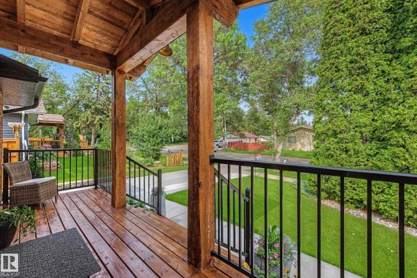 View from the covered wooden porch overlooking the front yard and street. - 160 Mission Av, St  Albert