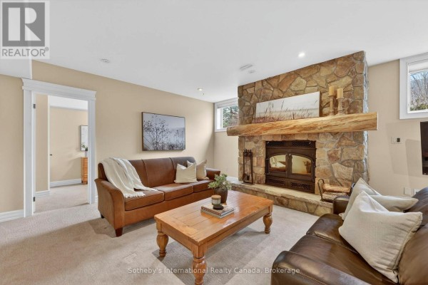 Stone fireplace with wood mantel and leather sofas - 160 Sunset Boulevard Blue Mountains