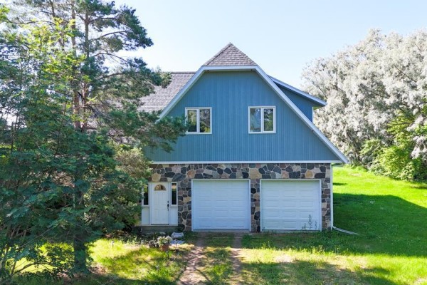 Rear aerial view of a blue house with a wooden deck, green lawn, and gravel driveway. - 160034 216  Ne 1/4 32-36-27w Road N, Swan River