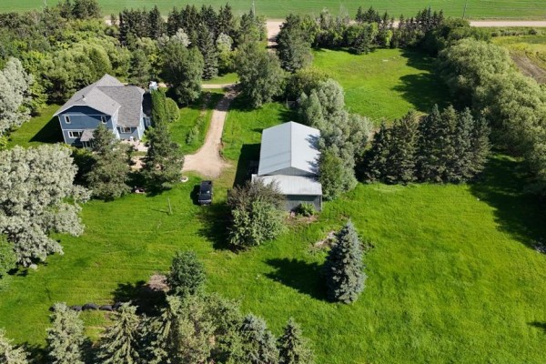 Kitchen with wood cabinets, stainless steel appliances, island, built-in banquette, and patterned tile floor. - 160034 216  Ne 1/4 32-36-27w Road N, Swan River