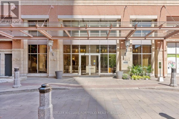 Close-up of the building entrance at 4090 Living Arts Drive with glass doors and awning. - 1602 - 4090 Living Arts Drive, Mississauga