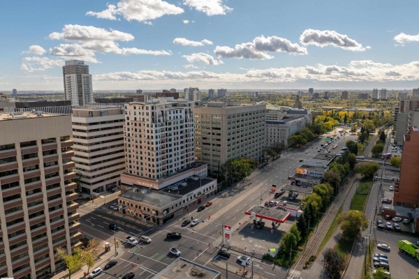 Aerial view looking down a city street with traffic, sidewalks, and buildings. - #1603 9939 109 St Nw, Edmonton