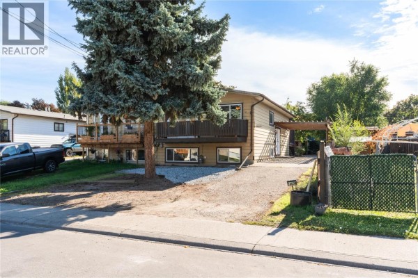 View of a beige duplex with a truck parked to the left of the property. - 1603b 45th Street, Vernon