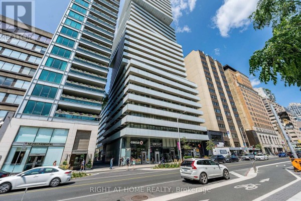 Exterior view of a tall residential building with a mixed glass and metal facade. - 1604 - 200 Bloor Street W, Toronto