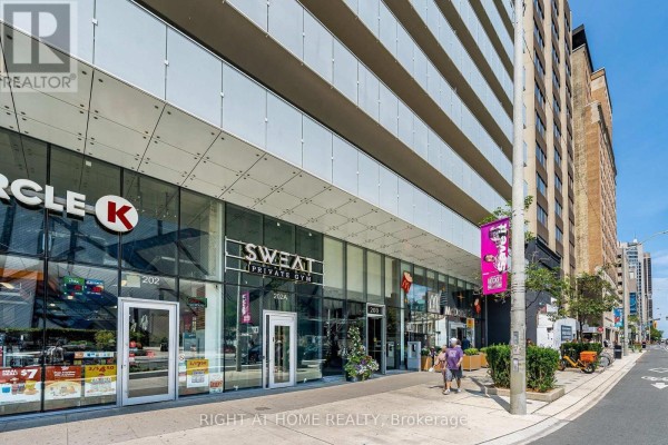 Ground level view of commercial storefronts including Circle K and McDonald's. - 1604 - 200 Bloor Street W, Toronto