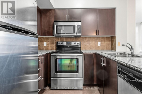 Kitchenette with dark wood cabinets, granite countertops, stainless steel appliances, and a tiled backsplash. - 1605 - 30 North Park Road, Vaughan
