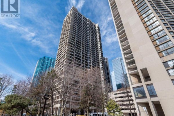 Exterior view of tall apartment buildings on a sunny day with blue sky. - 1605 - 65 Harbour Square, Toronto