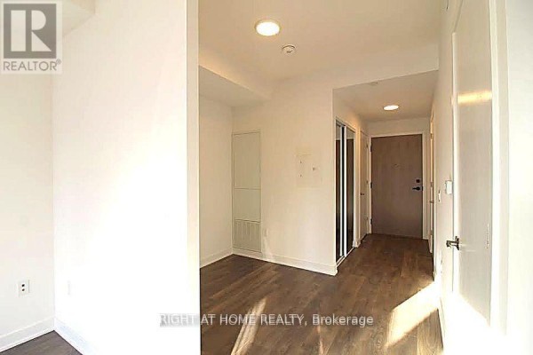 Interior hallway with dark wood floors and recessed closet. - 1606 - 130 River Street, Toronto