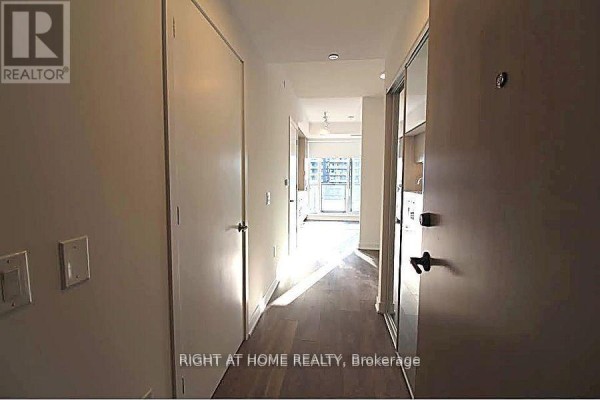 View down an apartment hallway towards living area and balcony. - 1606 - 130 River Street, Toronto