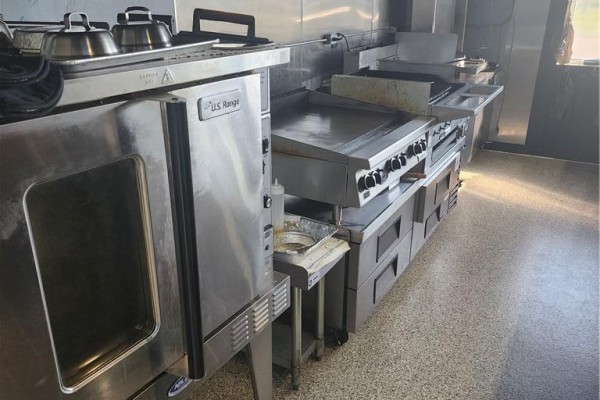 Commercial kitchen with stainless steel ovens, griddle, and ample counter space. - 1606 Battler Road Unit# A6, Kitchener