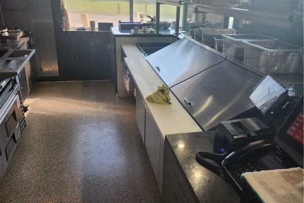 Commercial kitchen view showing stainless steel appliances, ventilation hood, and food preparation area. - 1606 Battler Road Unit# A6, Kitchener