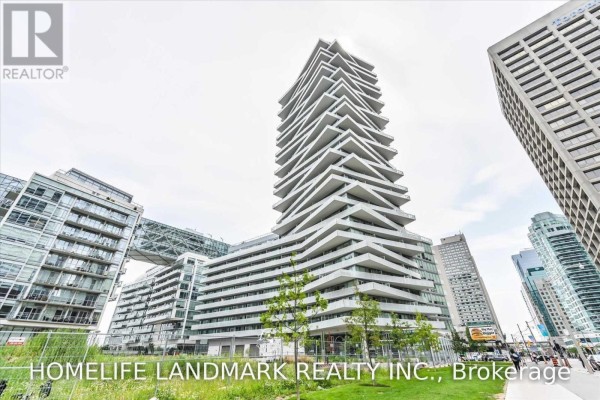 Street view of a distinctive white high-rise building with a stepped facade and surrounding modern architecture. - 1607 - 15 Queens Quay East Street, Toronto