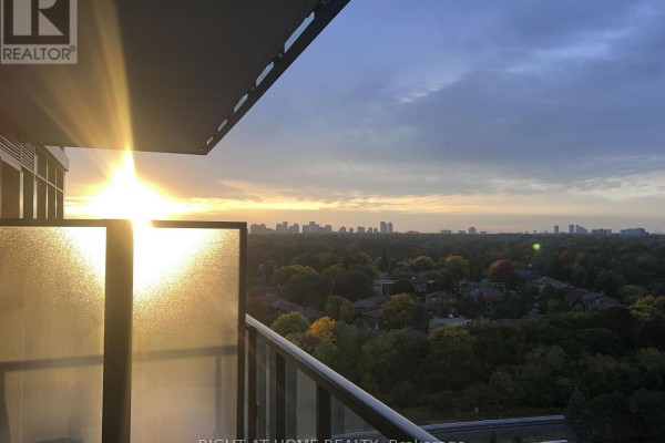 Sunrise over Toronto skyline viewed from a balcony with frosted glass panels. - 1607 - 29 Green Trail Court, Toronto