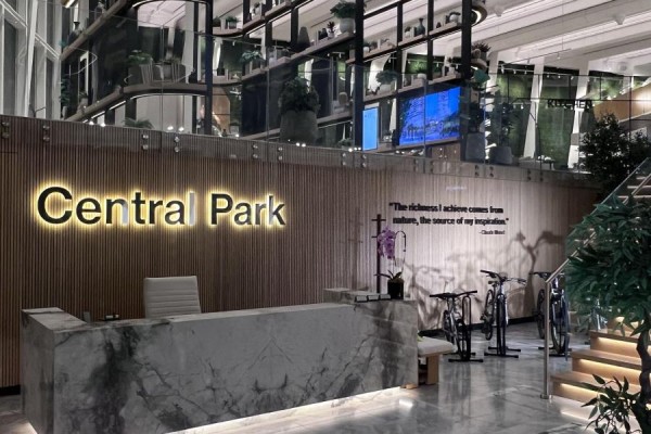 Hotel-style reception desk with marble front and illuminated "Central Park" sign. - 1607 - 29 Green Trail Court, Toronto