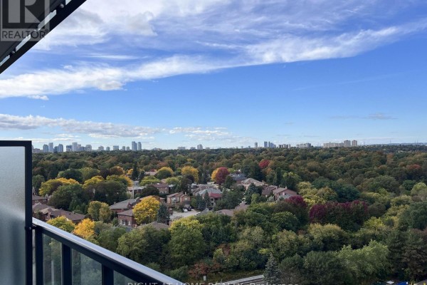 Expansive view of Toronto skyline and treed neighborhood from a high balcony. - 1607 - 29 Green Trail Court, Toronto