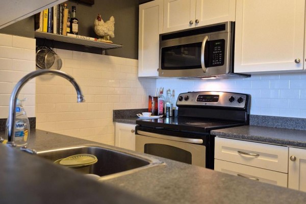 Compact kitchen with stainless steel appliances and white cabinetry - 1607 - 90 Dale Avenue, Toronto