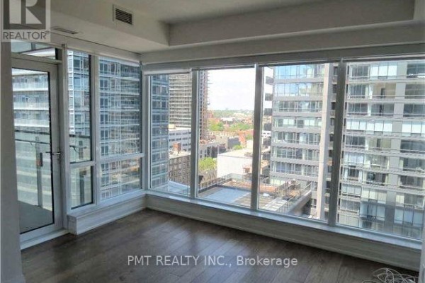 Living room with large corner windows offering city views and dark wood floors. - 1608 - 80 John Street, Toronto