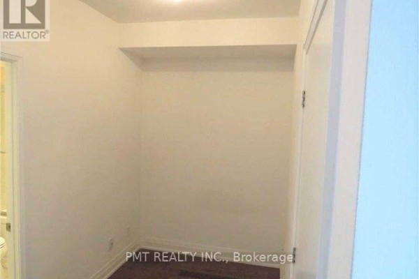Empty closet space with white walls and dark wood floors. - 1608 - 80 John Street, Toronto