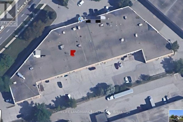 Aerial view of a commercial building with a large parking lot. - 161 Alden Road N, Markham