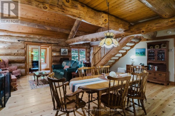 Small room with wooden ceiling, two windows overlooking trees, a desk, and a chair. - 161 Grey Street S, Saugeen Shores