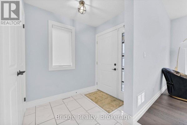 Entryway with stone pillars and front door featuring decorative glass - 161 Hemlock Street, Woodstock