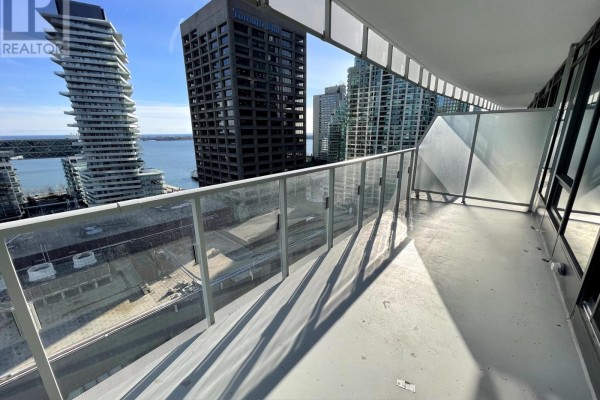 Balcony with glass railing offering expansive city and waterfront views. - 1610 - 28 Freeland Street, Toronto