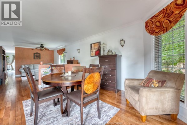 Foyer with vaulted ceiling, chandelier, white staircase railing, and tiled floor. - 1610 Chornoby Crescent, Tecumseh