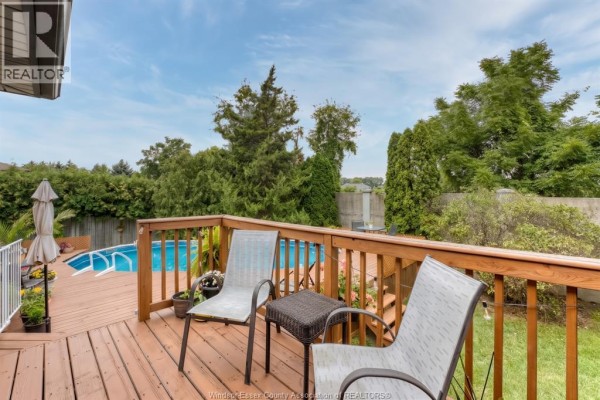 Deck with chairs and pool in backyard - 1610 Chornoby Crescent Tecumseh