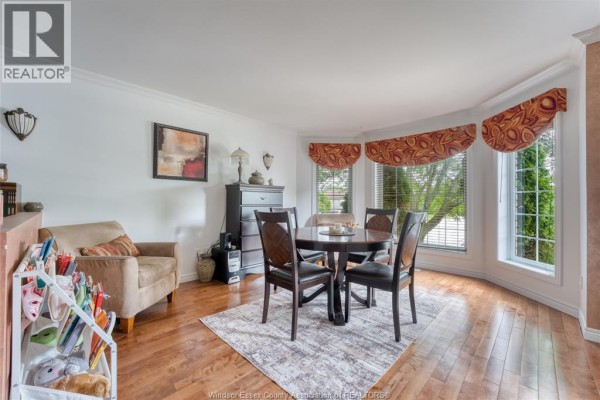 Dining area with round table, chairs, armchair, and bay window - 1610 Chornoby Crescent Tecumseh