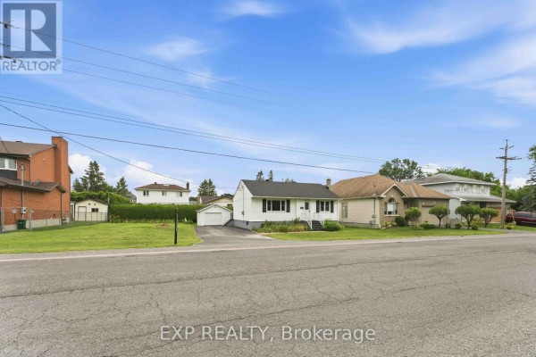 Street view of multiple residential properties with varying architectural styles. - 1613 Queensdale Avenue, Ottawa