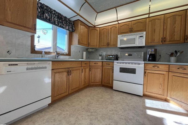 Corner view of the kitchen showing ample cabinet space and appliances. - 16131 110b Av Nw, Edmonton