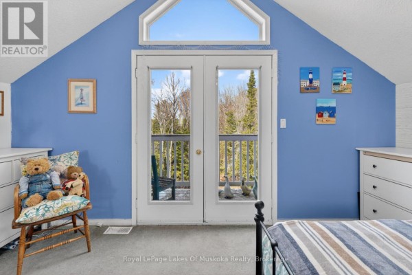 Bedroom with double doors and attic window overlooking trees - 1616 Skyline Drive Huntsville