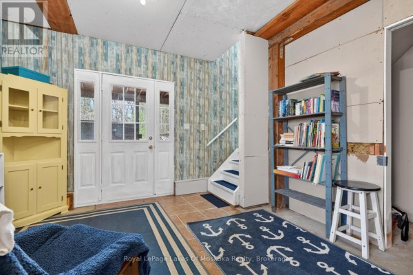 Double doors, yellow cabinet, bookshelf, and blue anchor rug - 1616 Skyline Drive Huntsville