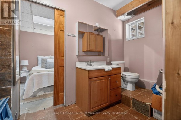 Bathroom with vanity, toilet, and view of bed - 1616 Skyline Drive Huntsville