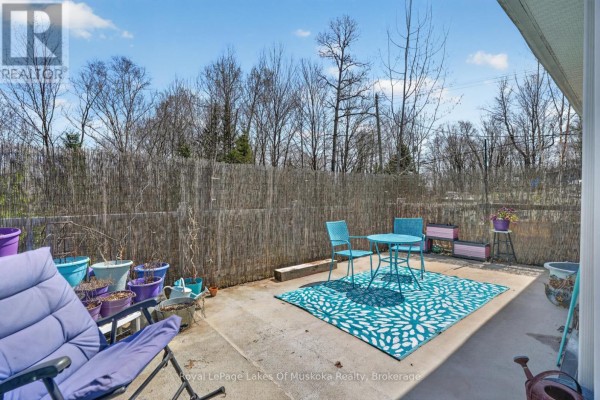 Patio with blue table, chairs, rug and potted plants - 1616 Skyline Drive Huntsville